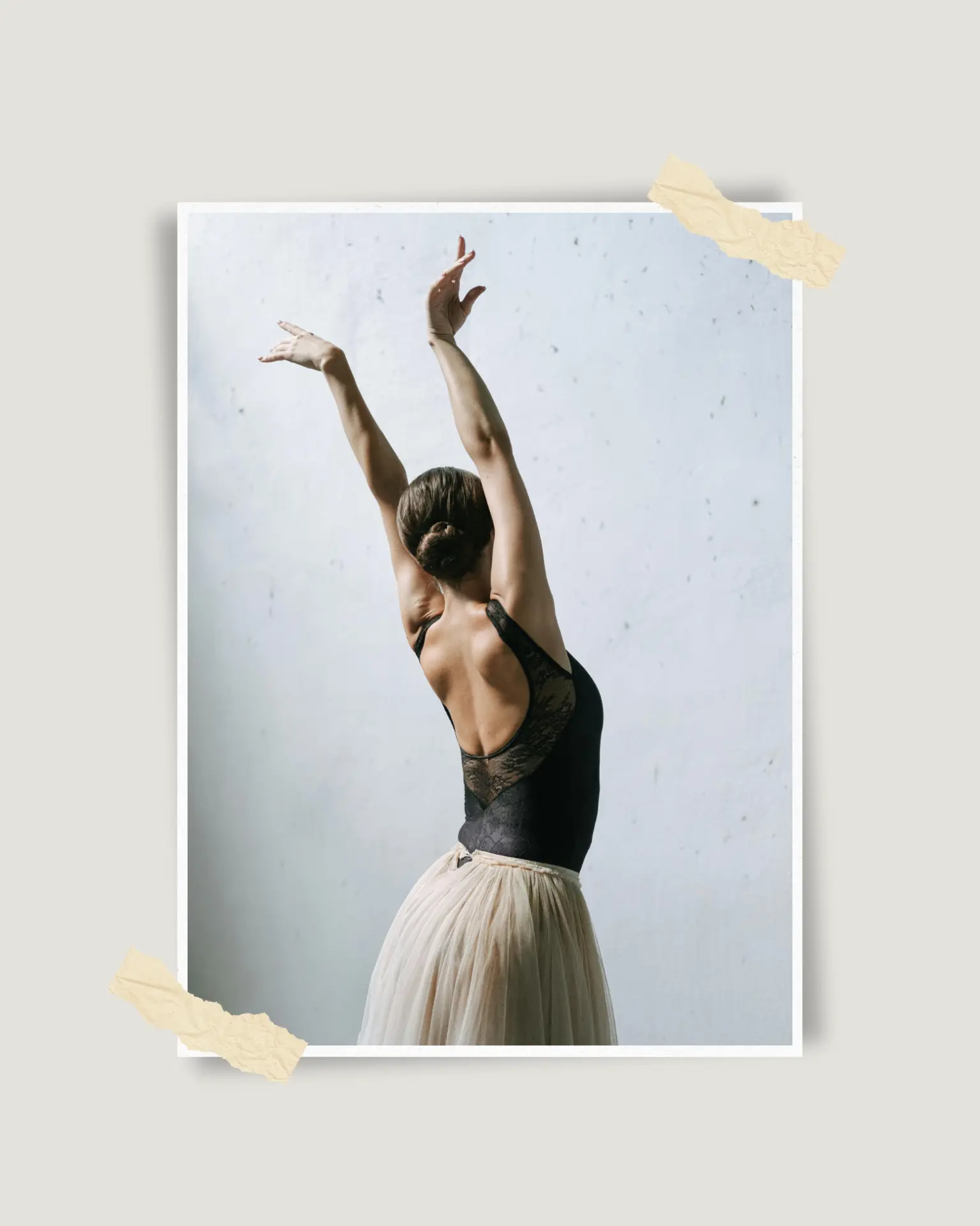 Dancer with arms raised, taped to a wall